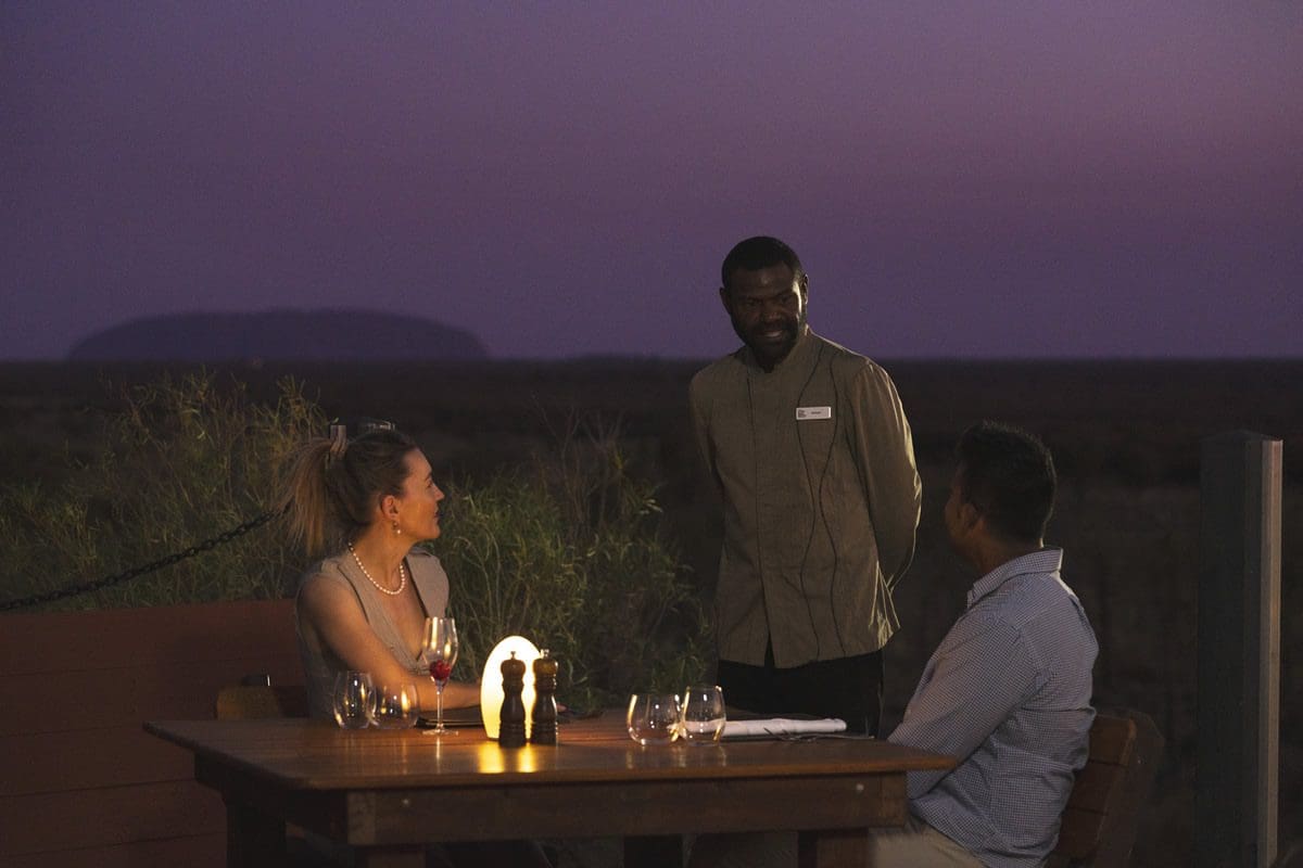 Fine dining experience enjoying views of Uluru - Tourism Australia