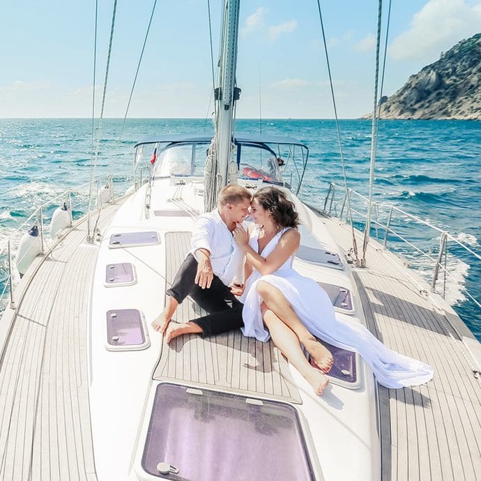 Couple aboard luxury sail boat