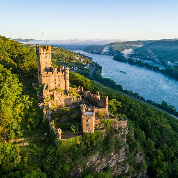 Aerial view of Sooneck Castle surrounded by the Bingen Forest with a view of the Rhine - Rheintouristik Tal der Loreley/Mahlow Media