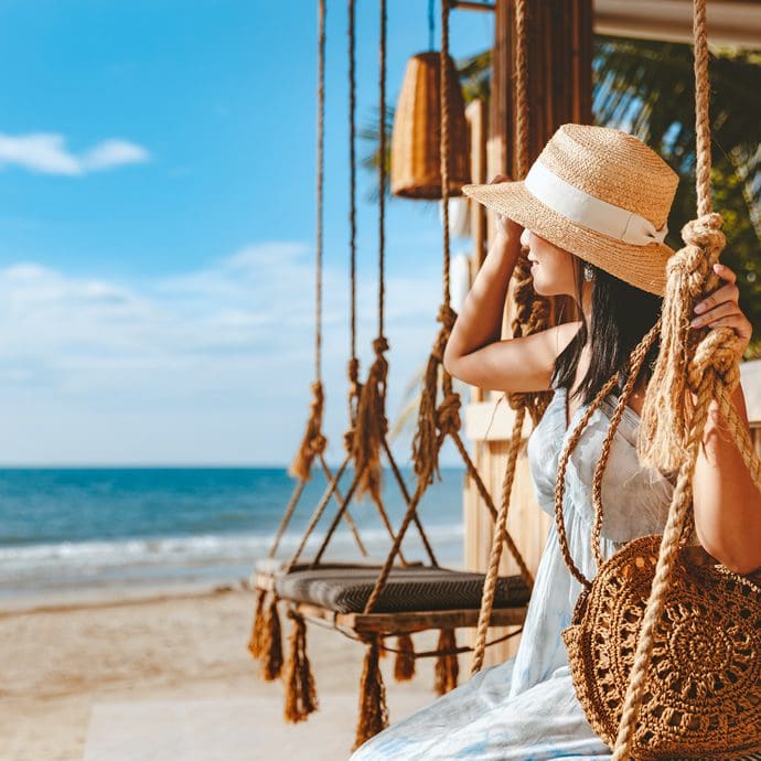 Female solo traveller relaxing by a Thai beach