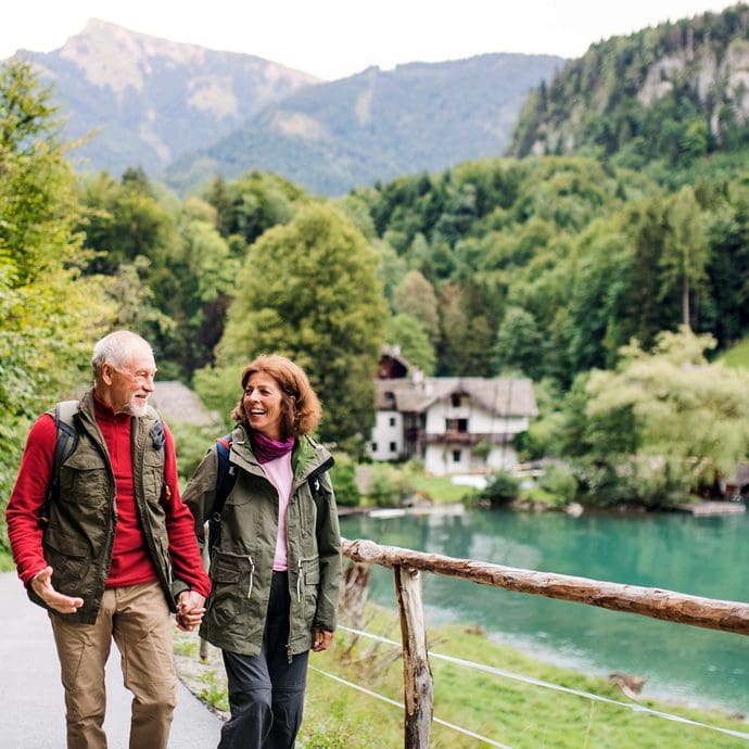 Couple walking in glorious lakes and mountains landscape