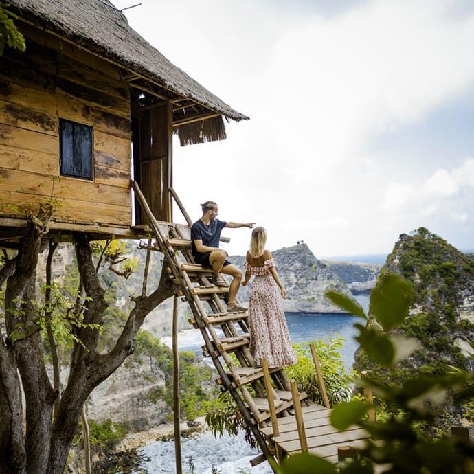 Couple enjoying the views from a tree house in Nusa Penida, Bali – Indonesia Tourism/Fikry Auliya Rahman