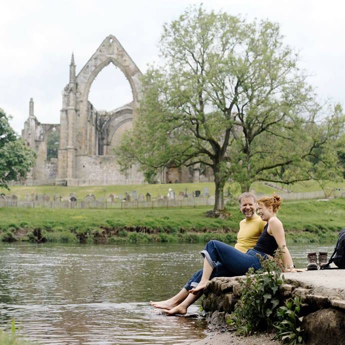 Dipping toes in the river at Bolton Abbey near Skipton - VisitBritain/Visit North Yorkshire/Tom Arber